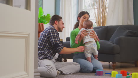 Transgender-Family-With-Baby-Playing-Game-With-Colourful-Toys-In-Lounge-At-Home