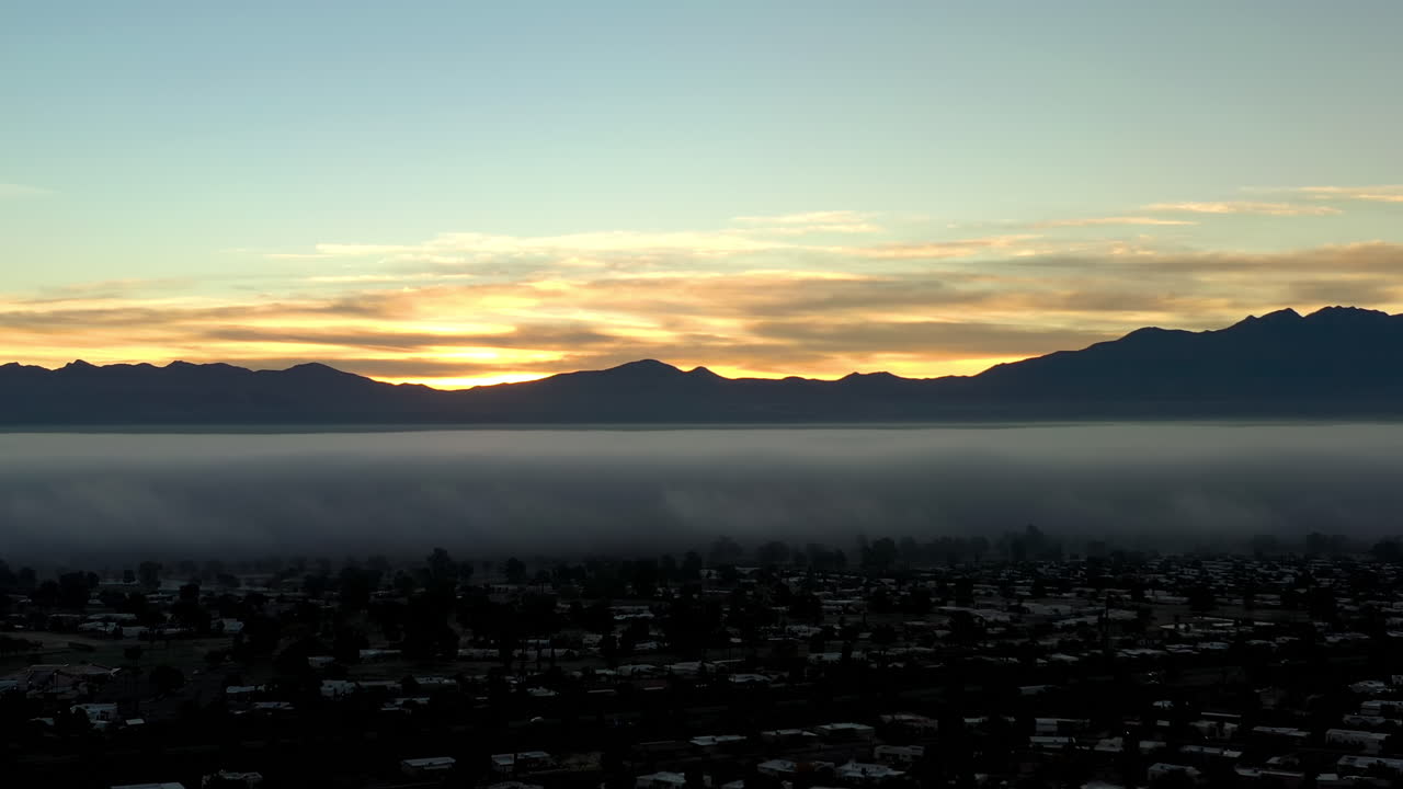 Fog blanket winter day in Arizona. City of Green Valley Pima County, drone moving forward.