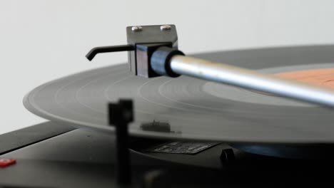 vinyl record player being switched on by a woman