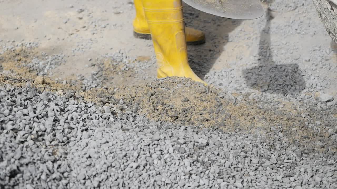 Construction Worker Mixing Concrete Materials