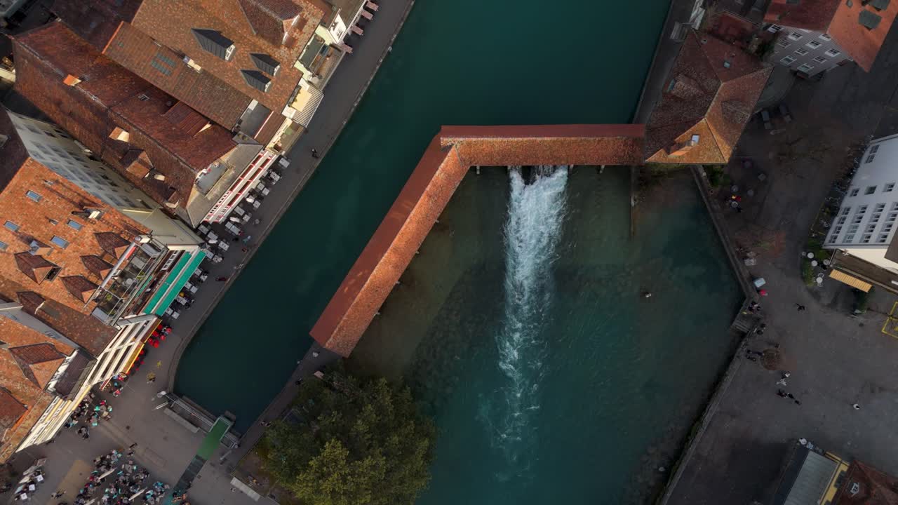 Covered bridge and sluice of Aare river in historic Thun town center