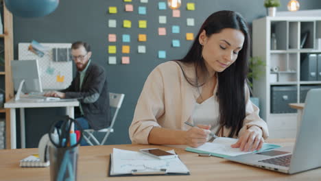 woman taking notes in a modern office