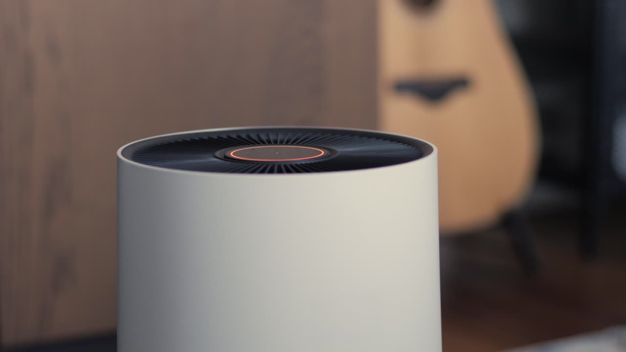 Modern air purifier in a stylish home interior, featuring a dynamic LED ring changing from blue to orange to red as it detects air quality levels
