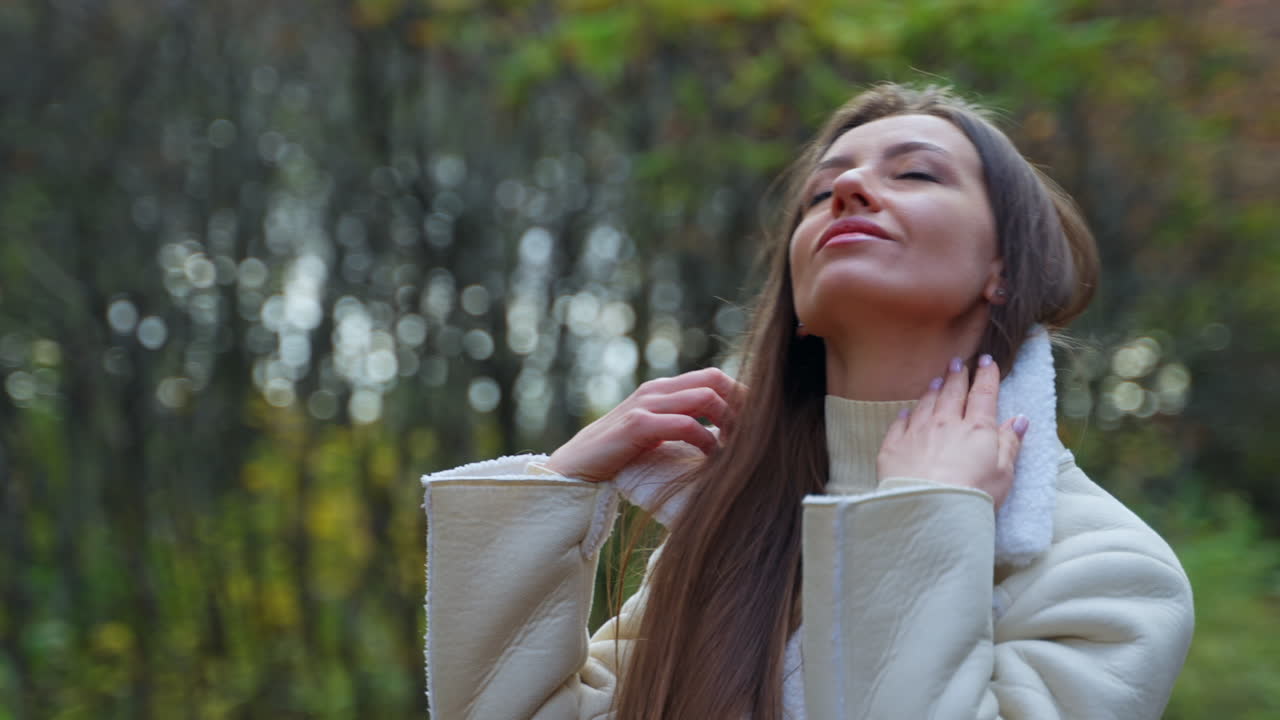 Woman in a Cream Coat in Autumn Park
