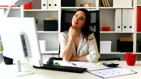 businesswoman sitting in office-chair and looking away