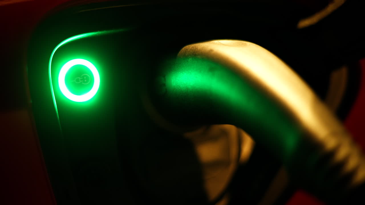 Close up of the charging port of an electric car at night