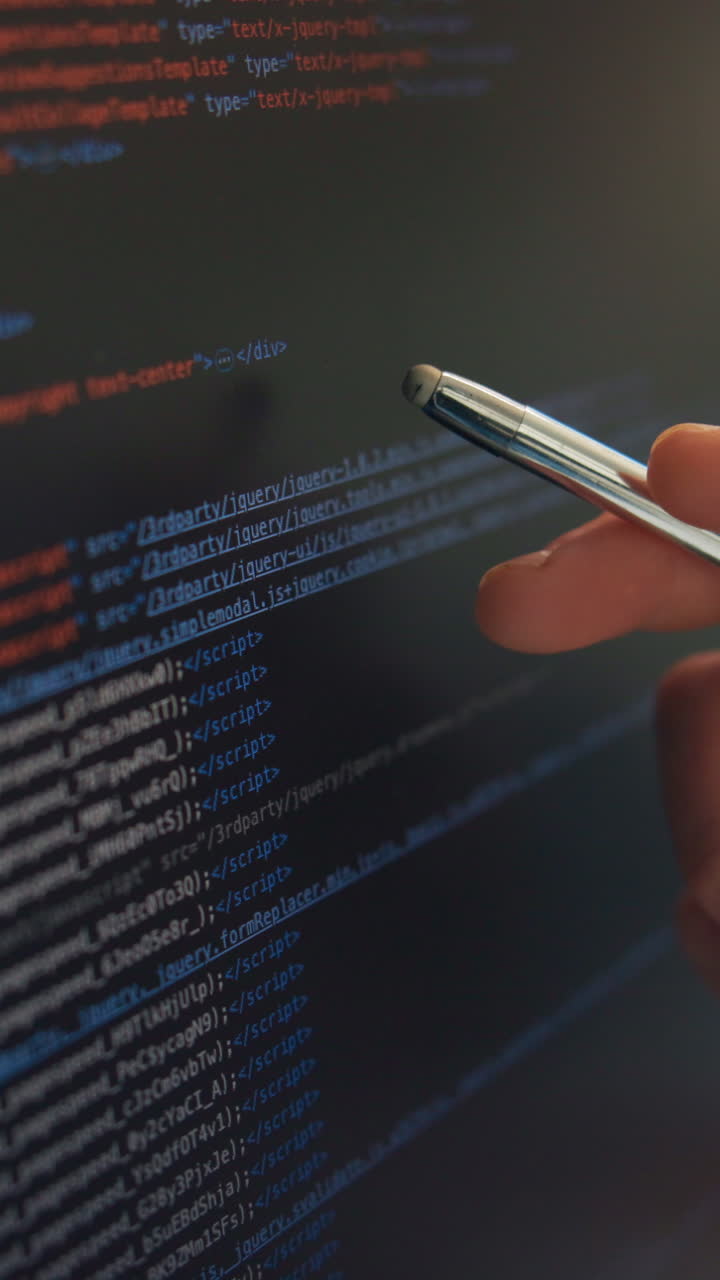 Hand Pointing Stylus at Scrolling Code on Computer Screen