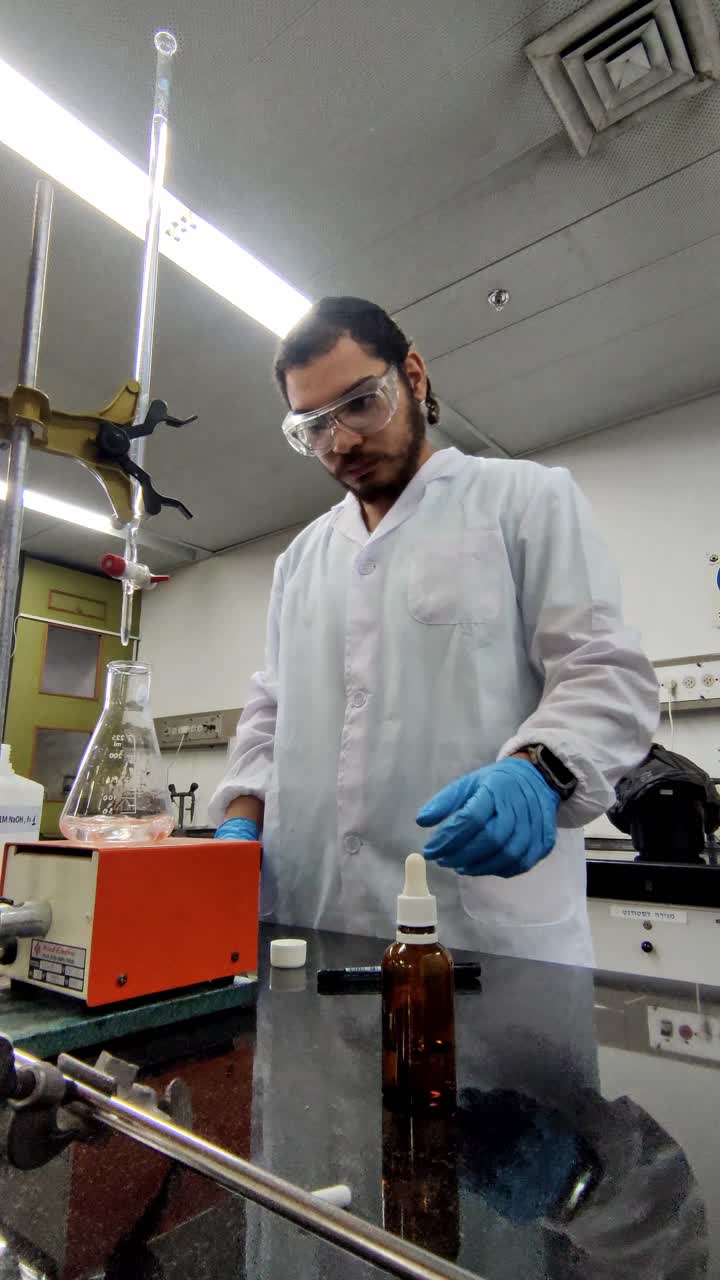A man in a lab coat is wearing gloves