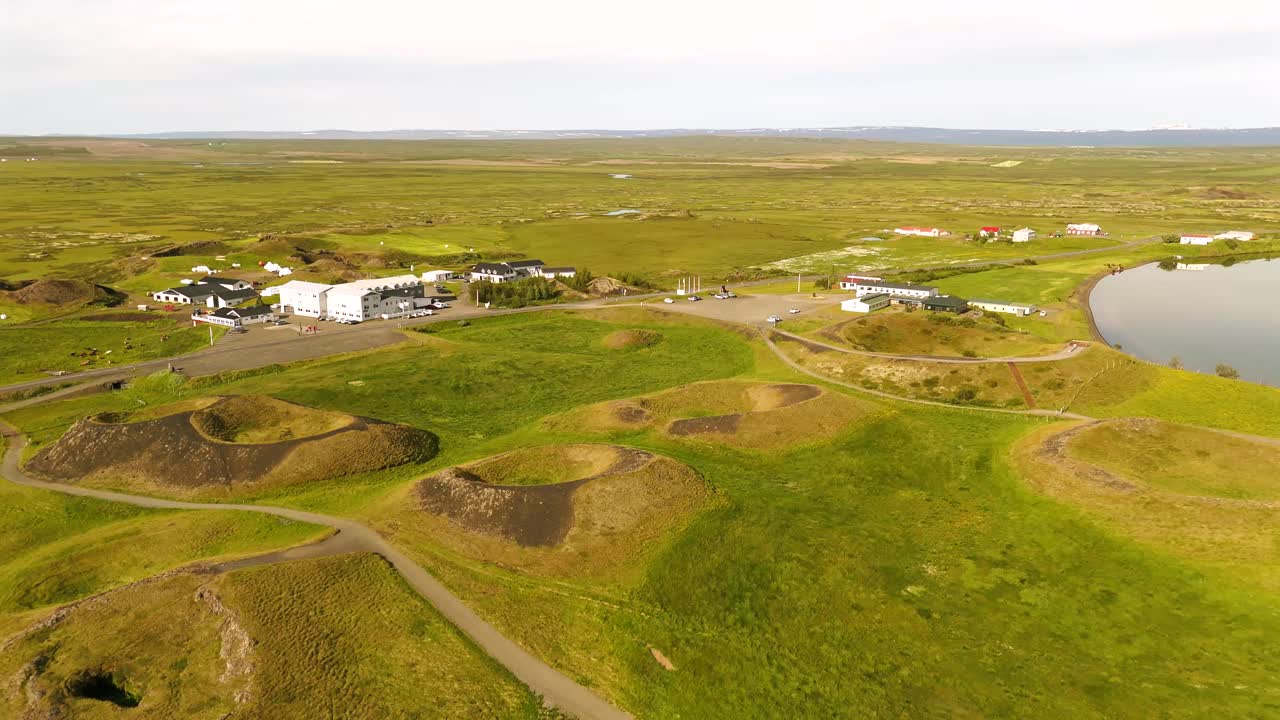 Experience a bird’s-eye view of Skútustaðagígar, showcasing its dramatic craters and lush surroundings, perfect for nature enthusiasts and photographers alike.