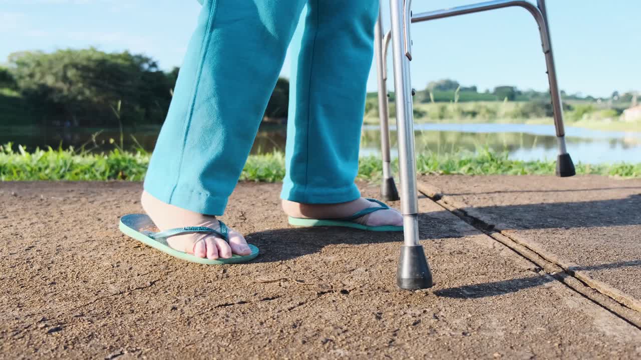 Person using walker with flip-flops outdoors
