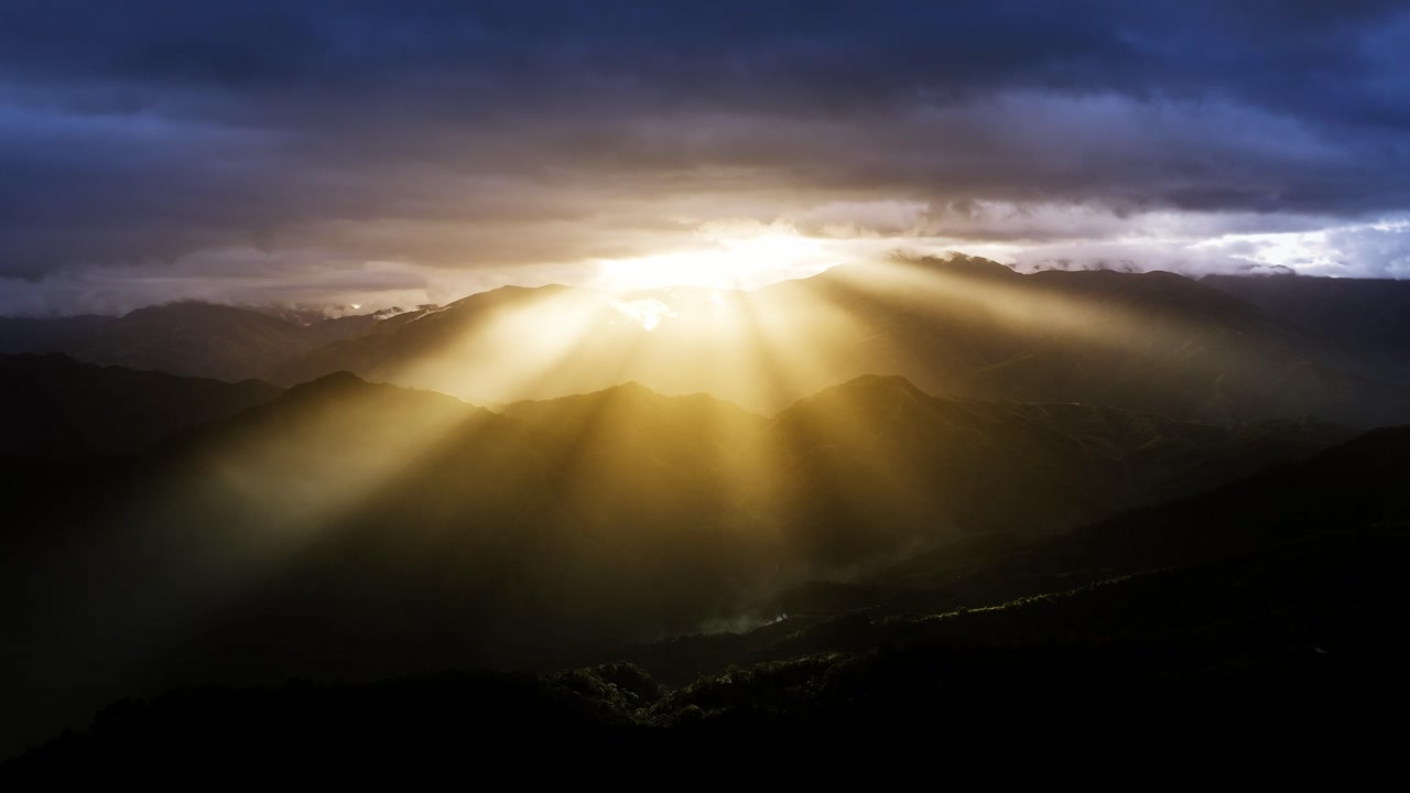 Slow zoom capturing powerful sun rays breaking through clouds over Hingyon