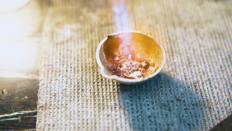 melting-gold-metal-in-crucible-with-flame-on-table-closeup