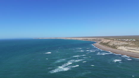 tranquil coastline of punta delgada, aerial of rugged cliffs and serene waters in patagonia argentina