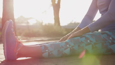 caucasian woman stretching in a park