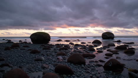 dusk at a rocky beach with spherical boulders