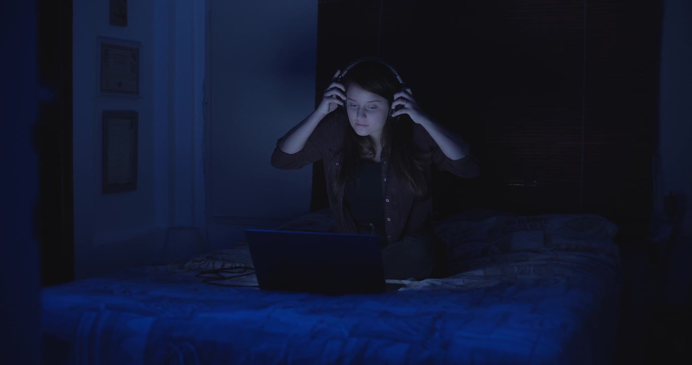 A young woman putting the headphones on