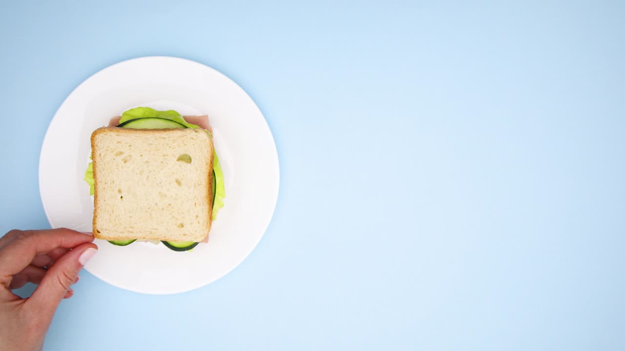 Making sandwich with salami and salad and pouring juice in glass for breakfast - Stop motion