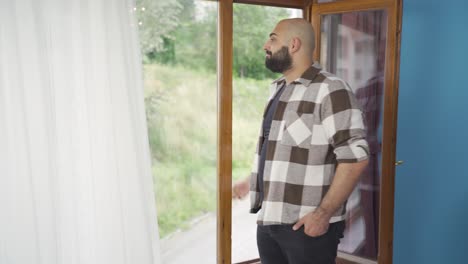 El-Hombre-Abre-Las-Cortinas-Cerradas-De-Su-Casa.