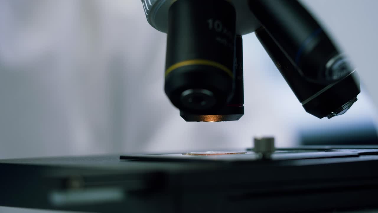 Close-up of Scientist Adjusting Microscope in a Laboratory