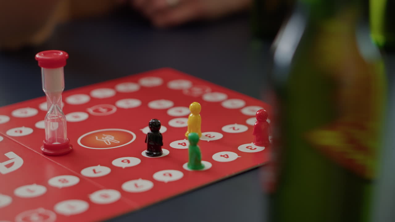 Young people playing charades board games with figurines