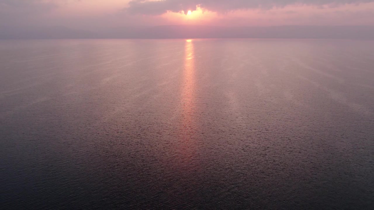 Aerial View of Serene Sunset with Golden Reflection on Calm Water