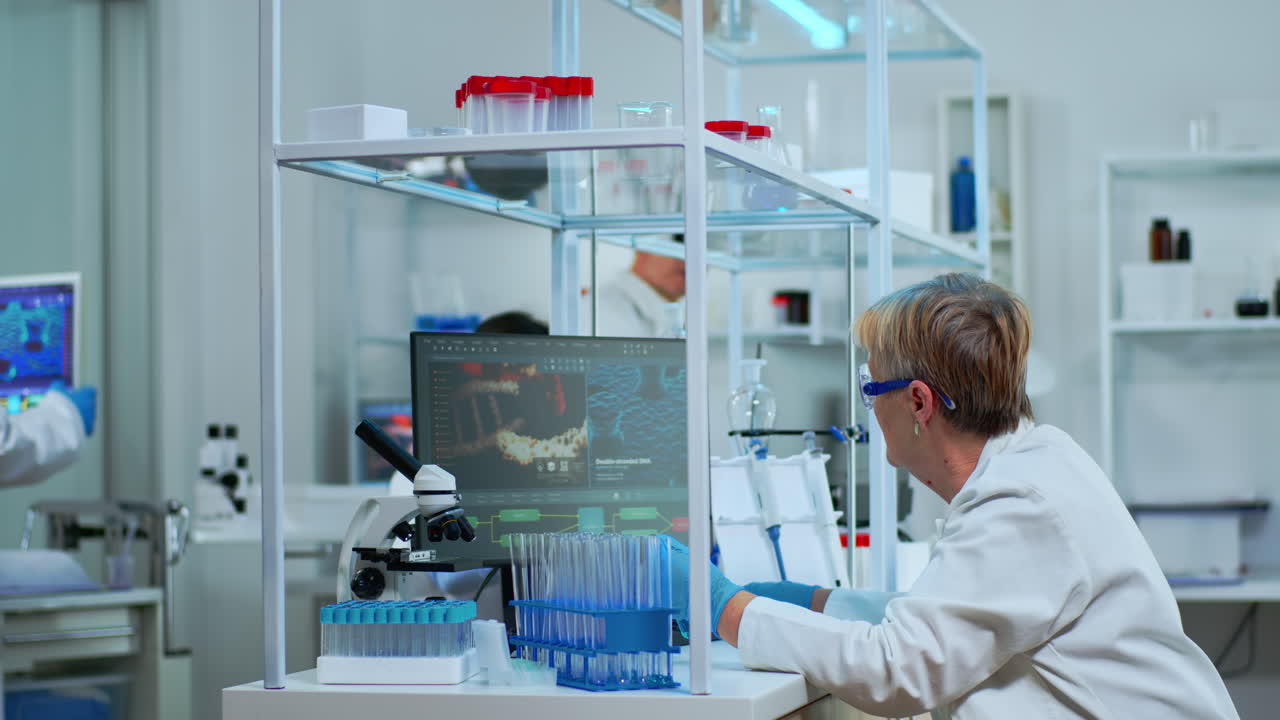 Microchemist doing research checking liquid in test tube at laboratory