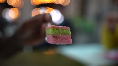 close-up shot colorful cake from street food market with blurred backgroun