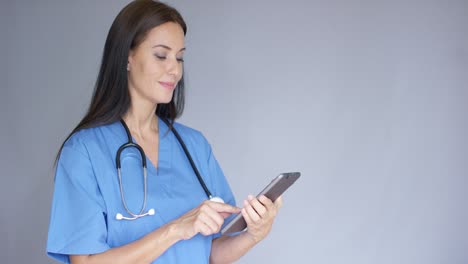 Thoughtful-young-woman-doctor-in-scrubs