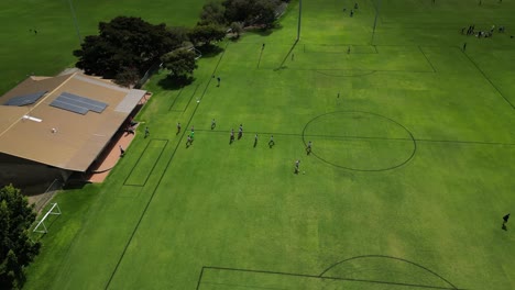 soccer players entering perth city field in australia for amateur football match