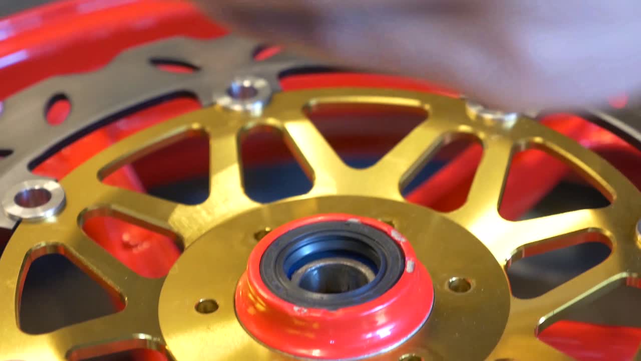 오토바이용 디스크 브레이크 설치 작업을 하는 정비공의 클로즈업 영상