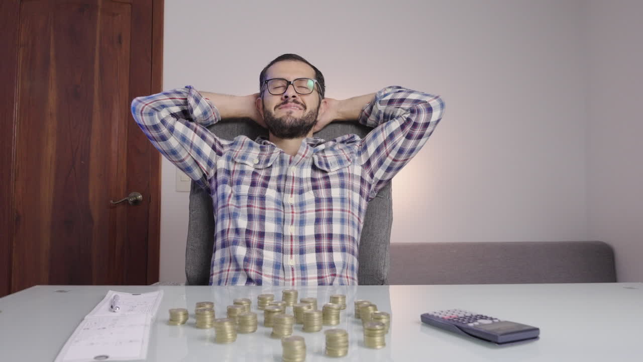 hombre haciendo contabilidad y contando monedas hace una cara de satisfacción feliz