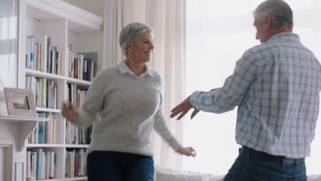 happy old couple dancing at home celebrating retirement anniversary having fun dance enjoying relationship milestone celebration 4k