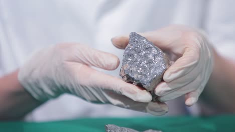 scientist examining a rock sample in a laboratory setting