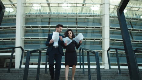 business couple walking with documents. couple discussing business papers