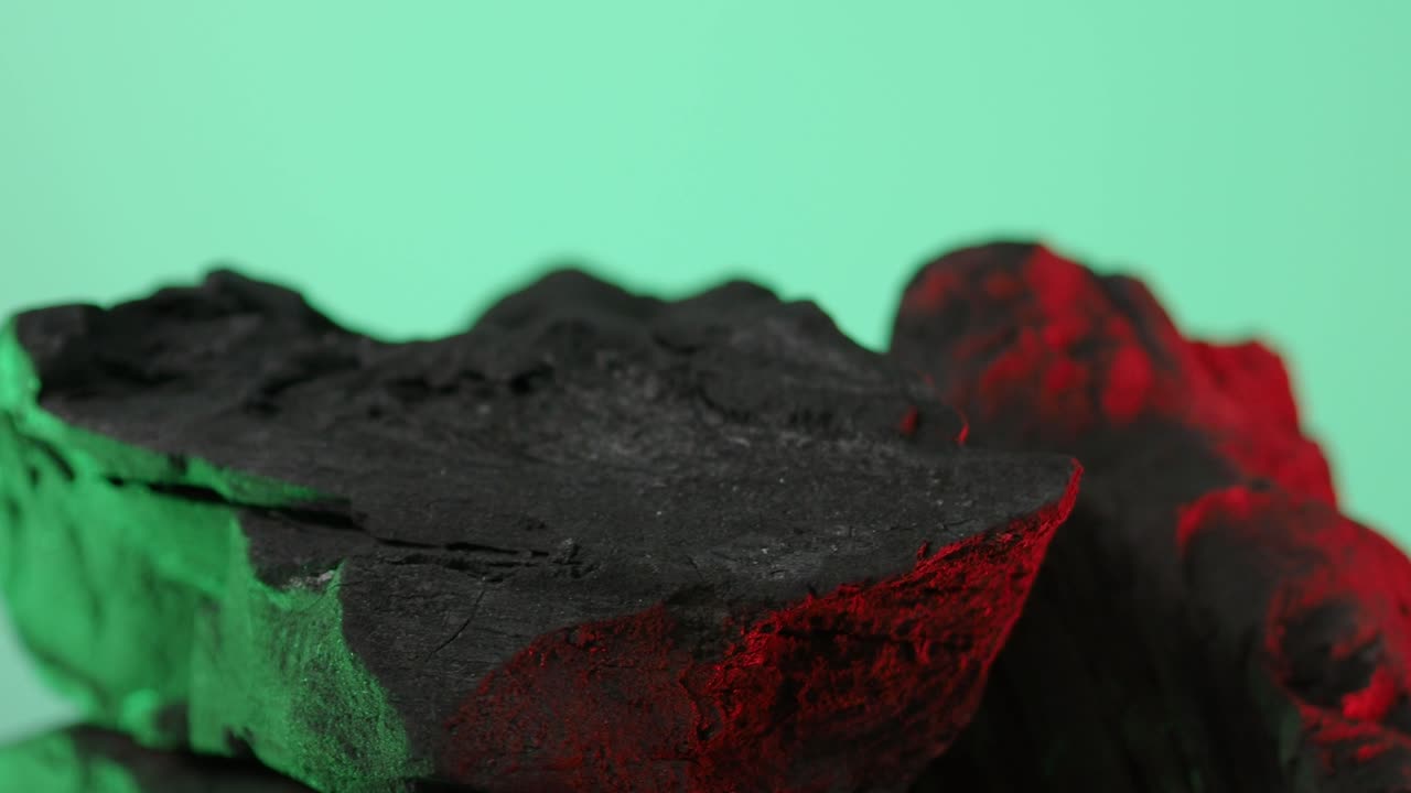 Wood charcoal. Black Charcoal on Blue green screen background. Used for cooking grill or industries. Natural wood charcoal. Black carbon reesidue produced by strongly heating wood. for grilled BBQ.