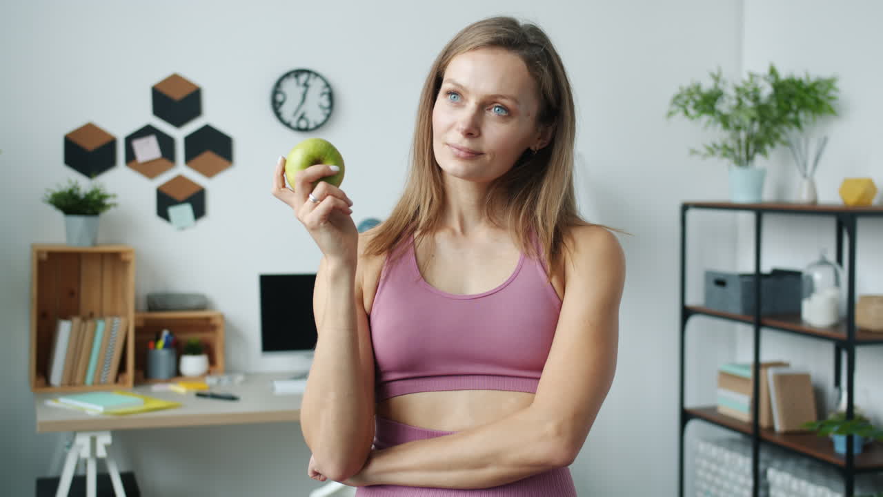 Woman Holding an Apple in a Home Office