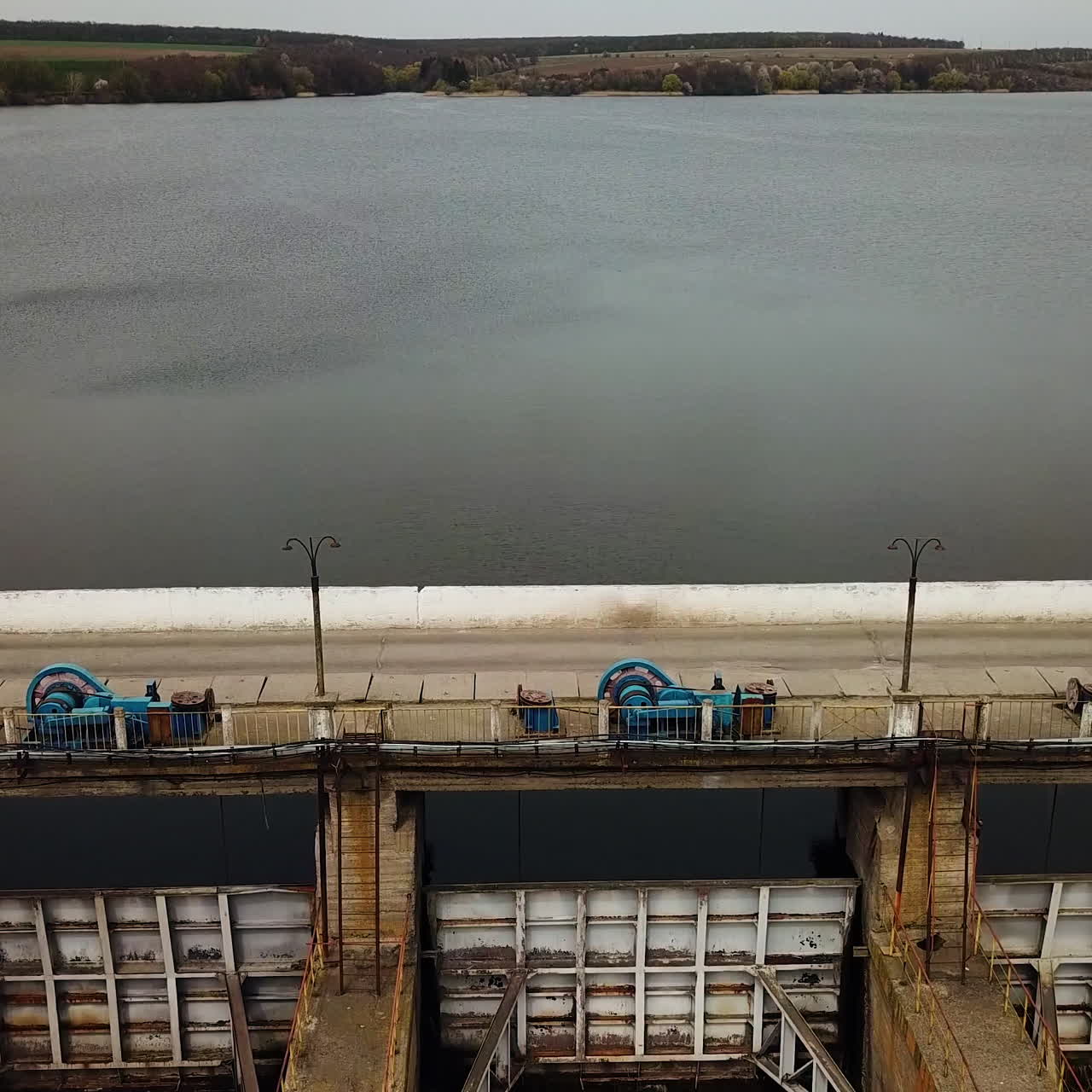 High water treatment plant is located on the river with a wonderful view on green fields and trees outside the city. Aerial landscape.