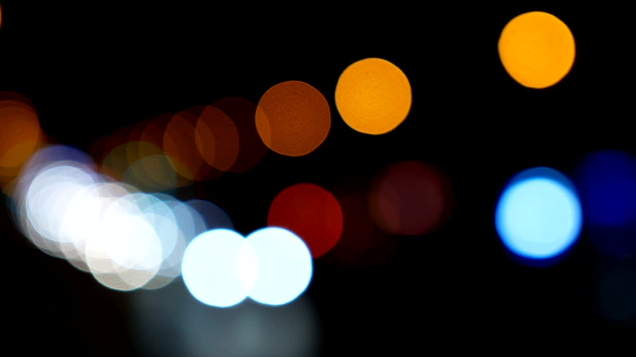 luces desenfocadas calle de los ángeles resumen. fondo borroso de la ciudad. círculos de bokeh en movimiento del tráfico nocturno.