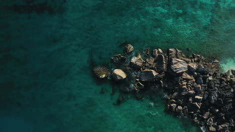 Waves-crashing-over-rocks-on-the-Island-of-La-Digue-in-the-Seychelles,-Africa