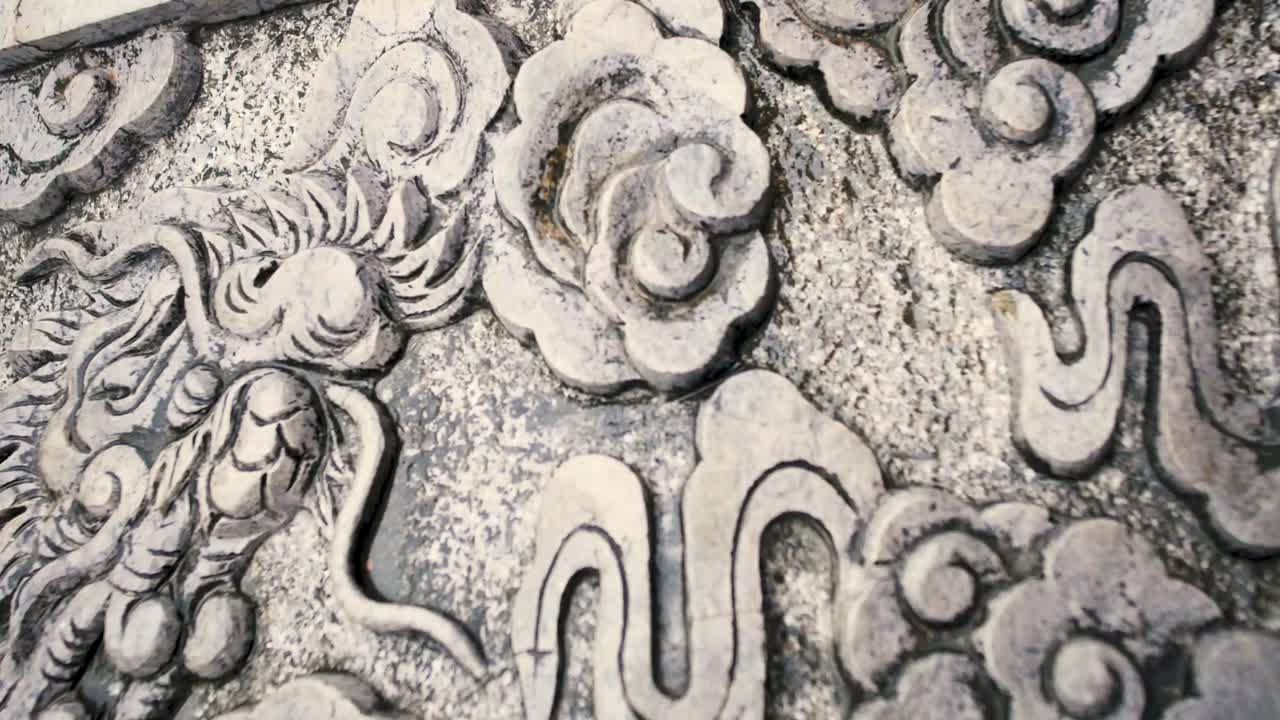 Intricate Stone Carving Design At The Ancient Temple Wall In Bai Dinh Pagoda Tower At The Province Of Ninh Binh, Vietnam. - Panning Shot