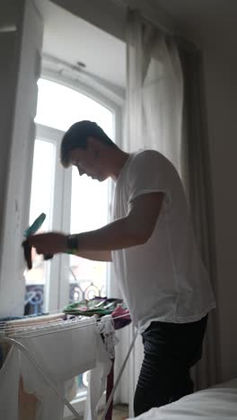 man doing laundry in a room