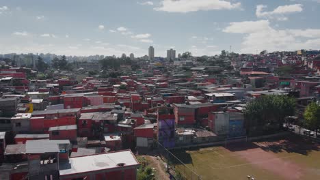 Aerial-landscape-image-of-favela-football-field---Flying-over-slum-in-district-of-Campo-Limpo,-São-Paulo-City-in-Brazil