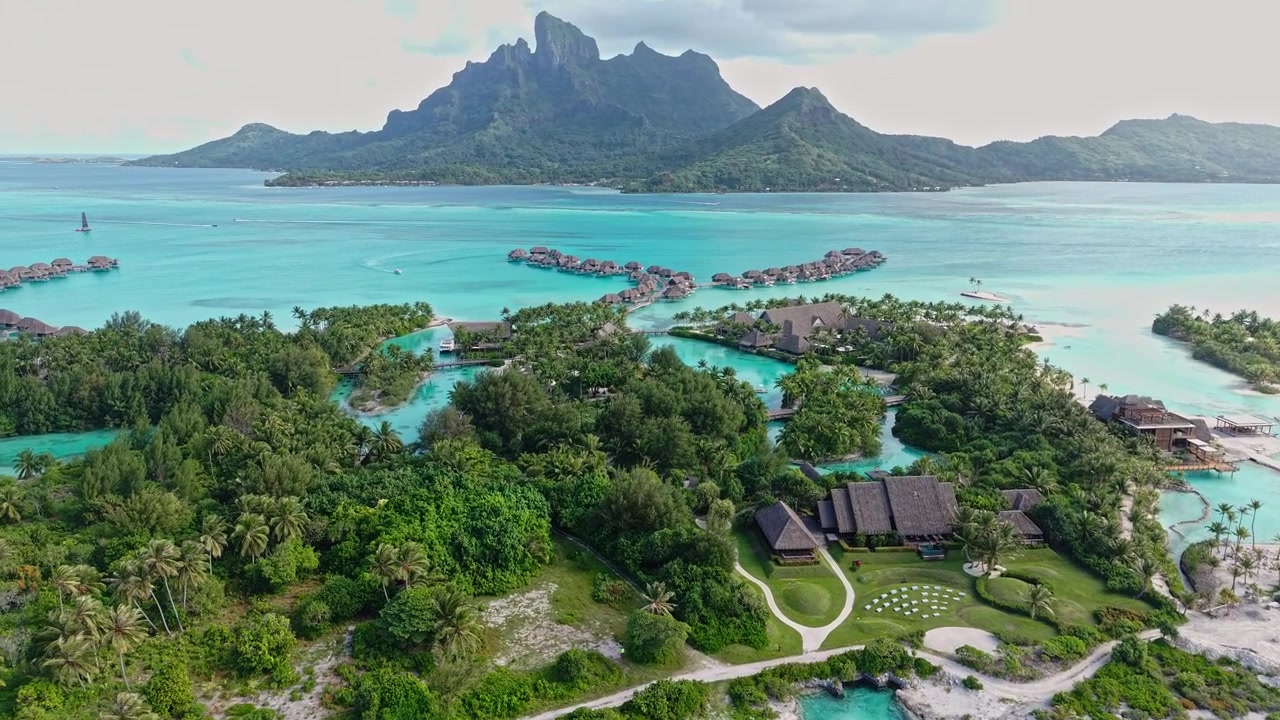 Bora Bora, French Polynesia. Drone Shot of Luxury Hotel Resort Buildings and Bungalows Over Turquoise Lagoon