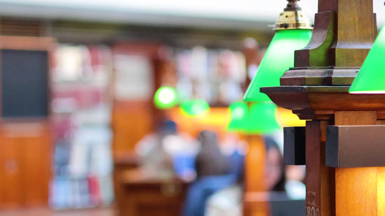 녹색 램프 를 가진 도서관 에서 공부 하는 사람 들