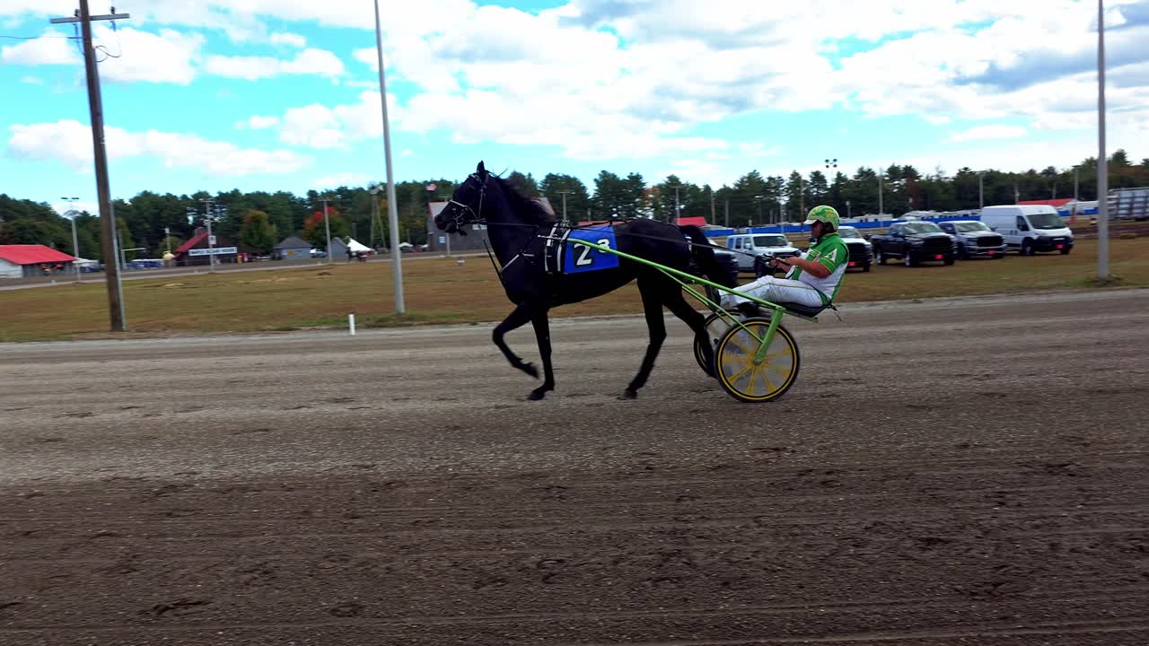 A sulky driver practices horse number 2 at the Cumberland Fair near Portland, Maine