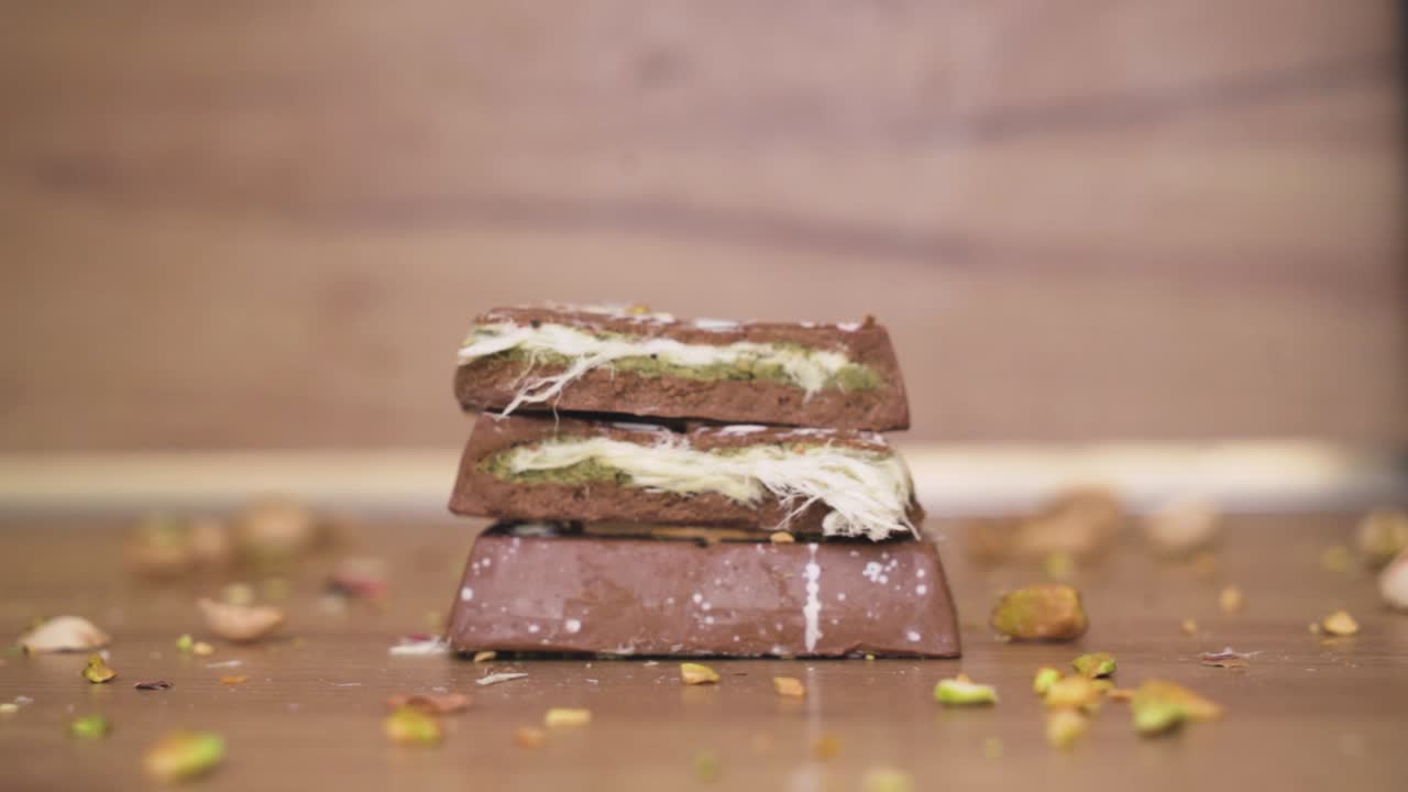 Elegant visual of artisan Dubai chocolate sprinkled with pistachio, emphasizing texture and indulgence