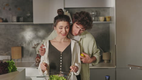 a couple cooking and embracing in a modern kitchen