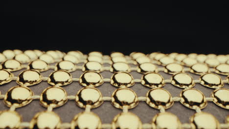 close-up of golden beads on a grid pattern