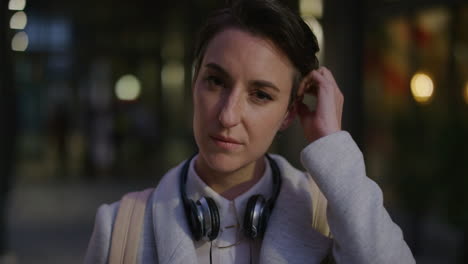 portrait professional young woman commuter running hand through hair looking calm businesswoman enjoying relaxed urban evening slow motion