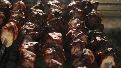 Shish-kebabs-grilling-on-open-fire-outdoors.-Bbq-cooking-on-backyard